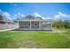Charming home with a screened-in porch, a well-manicured lawn, and lovely landscaping at 783 E Central Ave, Eagle Lake, FL 33839