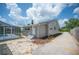 Home exterior next to screened-in pool and long driveway, landscaped with stone and mulch at 783 E Central Ave, Eagle Lake, FL 33839