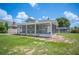 Home exterior featuring a covered porch, fresh landscaping, and a view of the pool at 783 E Central Ave, Eagle Lake, FL 33839