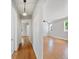 Hallway featuring hardwood floors, light gray walls, and white trim at 783 E Central Ave, Eagle Lake, FL 33839