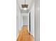 Hallway with hardwood floors, showcasing the home's layout and design at 783 E Central Ave, Eagle Lake, FL 33839