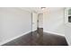 Living room with dark tile floors, paneled walls, white trim, and views to other rooms at 783 E Central Ave, Eagle Lake, FL 33839