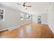 Sunlit living room with gleaming hardwood floors, neutral paint, and large windows at 783 E Central Ave, Eagle Lake, FL 33839