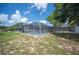 Screened-in pool area with a clear view of the backyard and mature trees at 783 E Central Ave, Eagle Lake, FL 33839