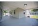 Spacious screened porch with outdoor lighting and a gray painted floor at 783 E Central Ave, Eagle Lake, FL 33839