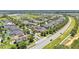 A picturesque aerial view showcasing a neighborhood complete with mature trees, sidewalks, and nearby roadways at 8120 Soldierwood St, Winter Garden, FL 34787