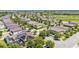 Aerial view of a residential neighborhood featuring sidewalks, mature trees, community pool and solar panels at 8120 Soldierwood St, Winter Garden, FL 34787