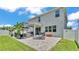 Large backyard with a stone patio, outdoor kitchen, and lush lawn, perfect for Gathering gatherings at 8120 Soldierwood St, Winter Garden, FL 34787