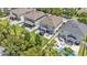 An aerial view of a home backyard featuring a covered patio, outdoor seating, and a sparkling swimming pool at 8120 Soldierwood St, Winter Garden, FL 34787