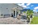 Gorgeous backyard featuring a stone patio, outdoor kitchen, and a green lawn at 8120 Soldierwood St, Winter Garden, FL 34787
