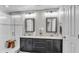 Elegant bathroom with dual vanity, framed mirrors, modern lighting fixtures, and glass enclosed shower at 8120 Soldierwood St, Winter Garden, FL 34787