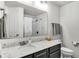 Bathroom featuring a large mirror, white countertop, and a toilet at 8120 Soldierwood St, Winter Garden, FL 34787