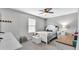 Comfortable bedroom with a ceiling fan, a large window, and carpeted floors at 8120 Soldierwood St, Winter Garden, FL 34787