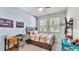 Cozy bedroom with a wooden bed frame, study desk, and posters on the baby blue accent wall at 8120 Soldierwood St, Winter Garden, FL 34787