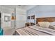 This is a large bedroom that includes a guitar on the wall and is well lit with natural light at 8120 Soldierwood St, Winter Garden, FL 34787