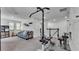 Spacious bonus room with neutral carpet, gray sofa, workout equipment, and lots of natural light at 8120 Soldierwood St, Winter Garden, FL 34787