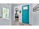 Inviting foyer features a brightly-colored front door, tile flooring, and views into the home at 8120 Soldierwood St, Winter Garden, FL 34787