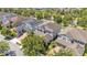 Aerial view of residential homes with brick driveways, attached garages, manicured lawns and mature trees at 8120 Soldierwood St, Winter Garden, FL 34787