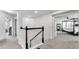 Upstairs hallway with carpet flooring and white walls leads to several bedrooms with open doorways at 8120 Soldierwood St, Winter Garden, FL 34787