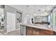 A modern kitchen features a granite island with stainless steel appliances, with views into the connected living areas at 8120 Soldierwood St, Winter Garden, FL 34787