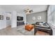 Spacious living room with modern decor, tile flooring, and a view of the dining room at 8120 Soldierwood St, Winter Garden, FL 34787
