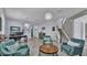 Bright living area featuring tile floors, turquoise seating, and views to front entry and stairs at 8120 Soldierwood St, Winter Garden, FL 34787