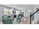 Open living area showcasing tile floors, contemporary lighting, and comfortable turquoise seating at 8120 Soldierwood St, Winter Garden, FL 34787