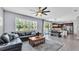 Open concept living room and kitchen with tile floors, ceiling fan and dining area with sliding glass doors at 8120 Soldierwood St, Winter Garden, FL 34787