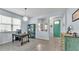 Open-concept living space featuring tile flooring, a stylish light fixture, and colorful decor at 8120 Soldierwood St, Winter Garden, FL 34787