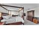 This main bedroom includes a four-poster bed, dark furniture, and neutral color palette at 8120 Soldierwood St, Winter Garden, FL 34787