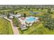 Aerial view of community pool, palm trees, lounge chairs and clubhouse by the lake at 8120 Soldierwood St, Winter Garden, FL 34787