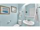 This home includes a quaint powder room with calming blue walls and a lovely framed mirror at 8120 Soldierwood St, Winter Garden, FL 34787