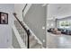 View of staircase with carpet steps and white railings leading to the upper level of the home at 8120 Soldierwood St, Winter Garden, FL 34787