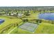 Aerial view of a community tennis court near a lake and pool area at 8120 Soldierwood St, Winter Garden, FL 34787