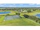 Aerial view of a community tennis court near a lake and pool area at 8120 Soldierwood St, Winter Garden, FL 34787