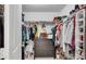Organized walk-in closet featuring ample hanging space, shelving, and a chest of drawers for storage at 8120 Soldierwood St, Winter Garden, FL 34787
