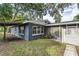 A back view of a single Gathering residence with a covered walkway and large sliding glass doors to the lanai at 906 E Lowell St, Lakeland, FL 33805
