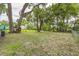 Spacious, green backyard enclosed by chain-link fence and shaded by mature trees at 906 E Lowell St, Lakeland, FL 33805