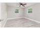 Light filled bedroom with wood-look floors, ceiling fan, and neutral paint at 906 E Lowell St, Lakeland, FL 33805