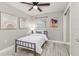 Cozy bedroom with a black metal bed frame, light walls, and a mirrored closet door at 906 E Lowell St, Lakeland, FL 33805