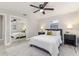 Bedroom featuring a mirrored closet, ceiling fan, light walls, and modern decor at 906 E Lowell St, Lakeland, FL 33805