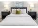Comfortable bedroom with soft bedding, side tables, lamps, and window views for a peaceful ambiance at 906 E Lowell St, Lakeland, FL 33805