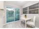 Bright dining area with sliding glass doors and white table set for a cozy eating experience at 906 E Lowell St, Lakeland, FL 33805
