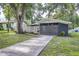 Single Gathering home featuring a well-kept yard, concrete driveway, and an inviting covered front entry at 906 E Lowell St, Lakeland, FL 33805