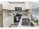 Bright kitchen featuring stainless steel appliances, marble countertops and stainless steel sink at 906 E Lowell St, Lakeland, FL 33805