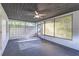 Spacious, screened-in lanai with a ceiling fan and view of the outdoors, perfect for relaxation at 906 E Lowell St, Lakeland, FL 33805