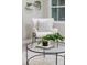 Cozy living room nook with stylish chair, glass table, and hanging plants for a modern touch at 906 E Lowell St, Lakeland, FL 33805