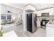 Open-concept living space with modern kitchen flowing into comfortable living room with gray sofa at 906 E Lowell St, Lakeland, FL 33805