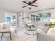 Open-concept living room showcasing modern decor, hardwood floors, and access to other areas of the home at 906 E Lowell St, Lakeland, FL 33805