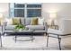 Bright living room featuring a gray sofa, armchair, and modern decor at 906 E Lowell St, Lakeland, FL 33805